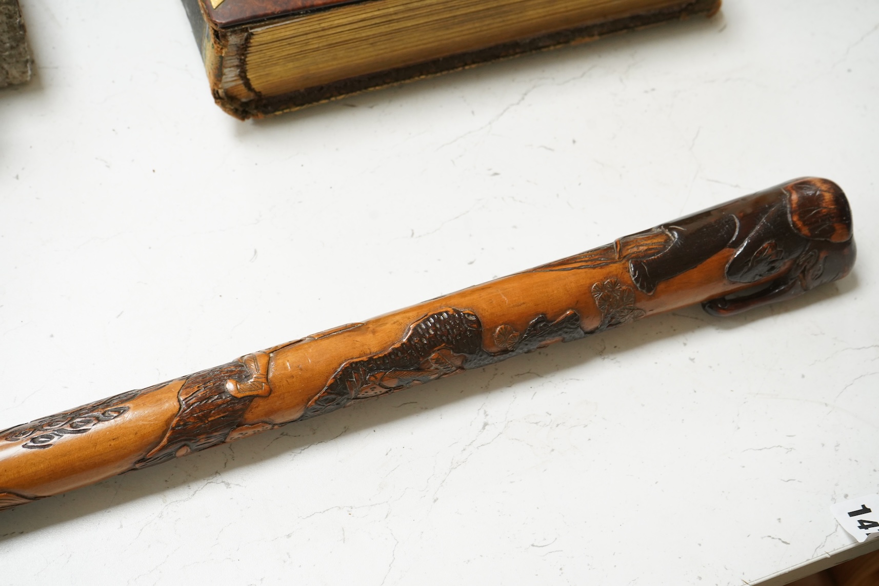 A late 19th century Japanese carved walking stick, with elephant handle, 95cm high